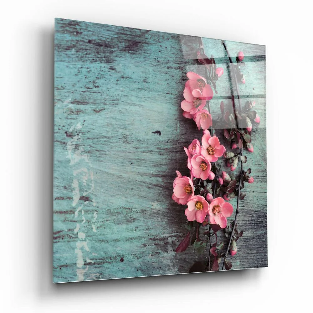 Stunning glass wall art of pink flowers on teal wood background