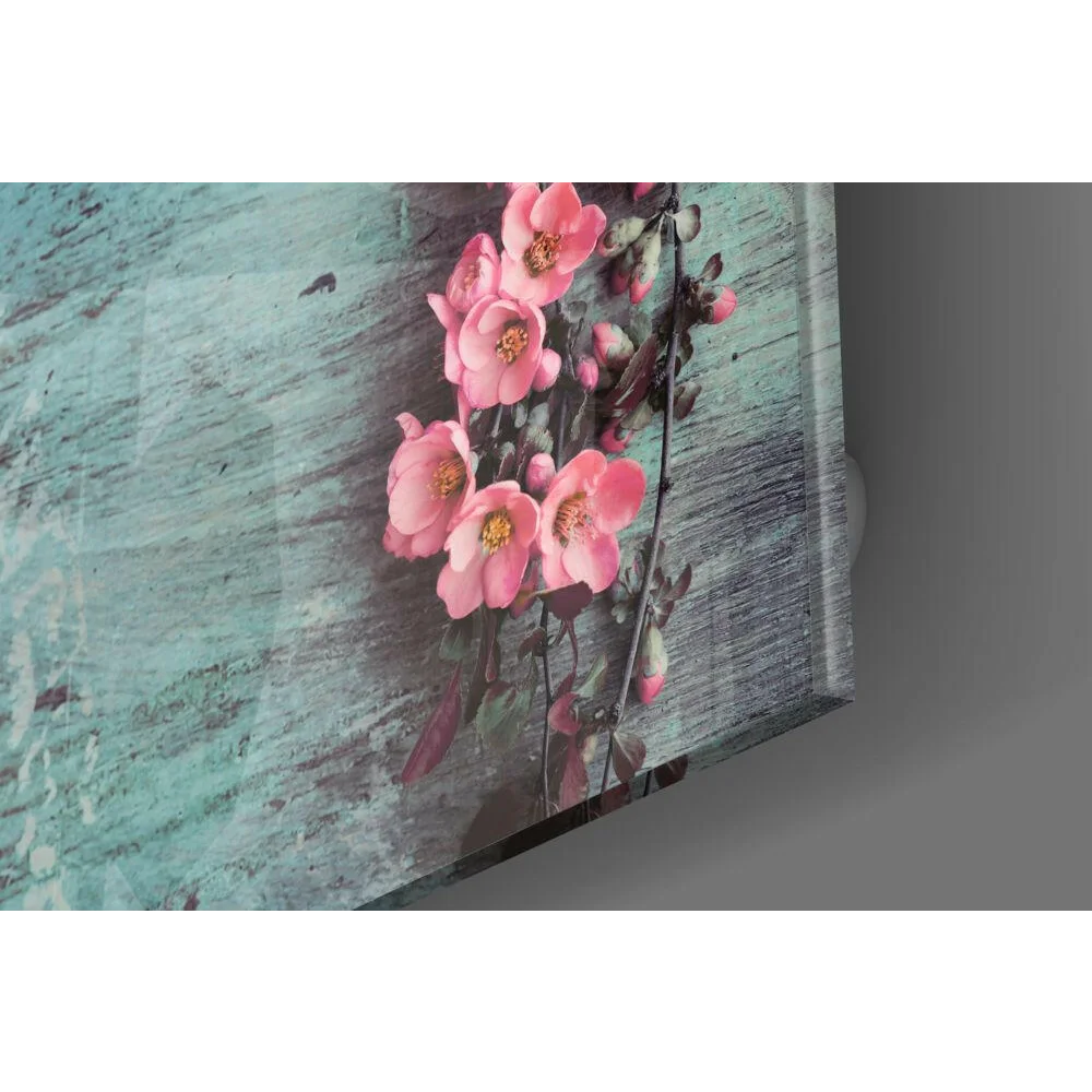 Stunning glass wall art of pink flowers on teal wood background