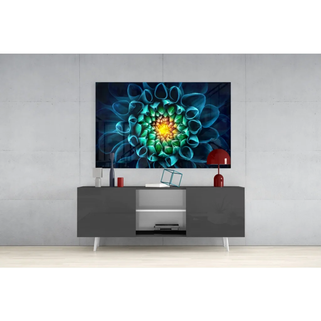 Vibrant glass wall art of teal green flower with glowing yellow center