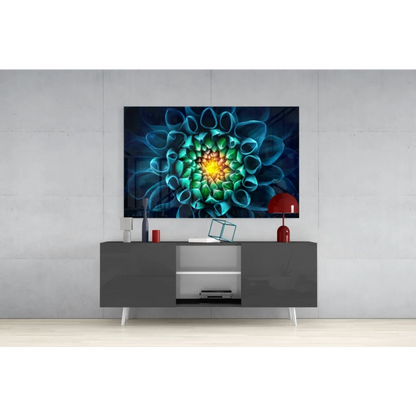 Vibrant glass wall art of teal green flower with glowing yellow center
