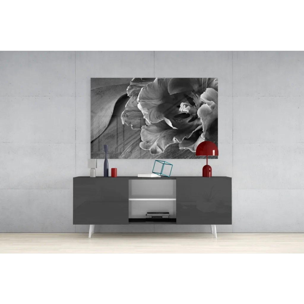 Black-and-white floral glass wall art print above gray console