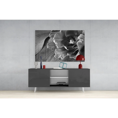 Black-and-white floral glass wall art print above gray console