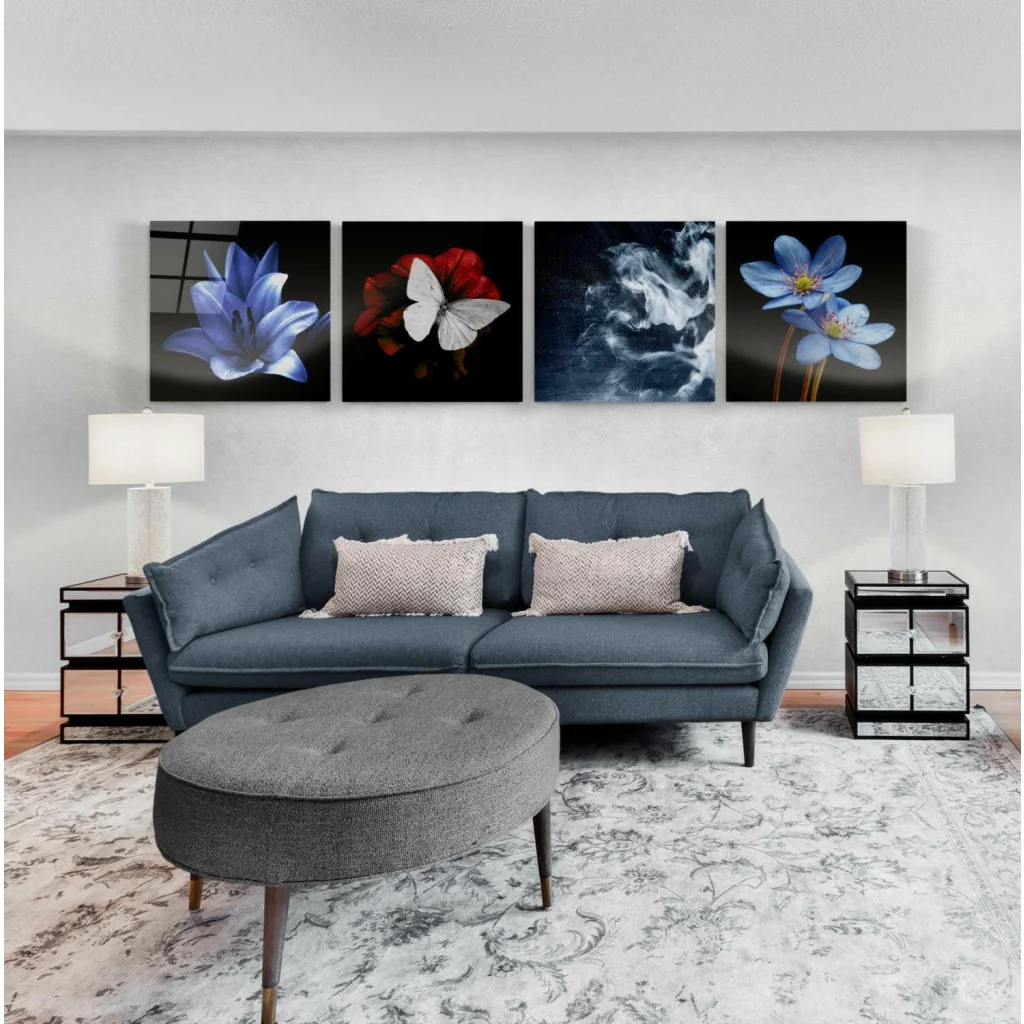 Stunning glass wall art set with vibrant flowers, butterfly, and dark blue tufted sofa with light gray patterned pillows