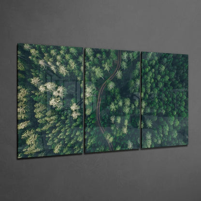 Three-panel green forest aerial view wall art on dark gray surface