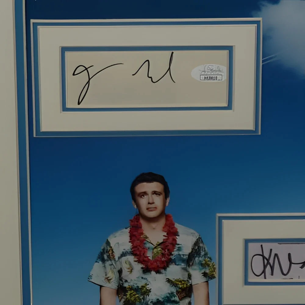 Man in Hawaiian shirt under Forgetting Sarah Marshall framed autographs