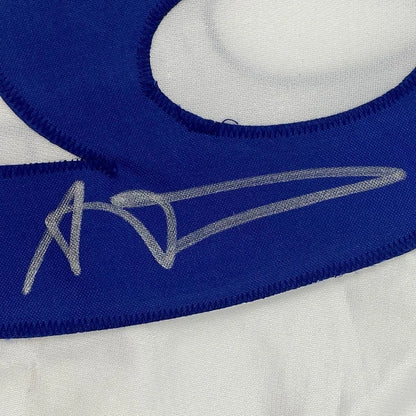 Autographed blue Rams jersey patch with white stitching from Aaron Donald for display