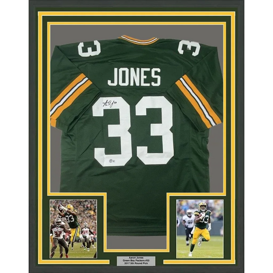 Back side of a framed autographed Aaron Jones green and yellow Green Bay Packers football jersey with number 33