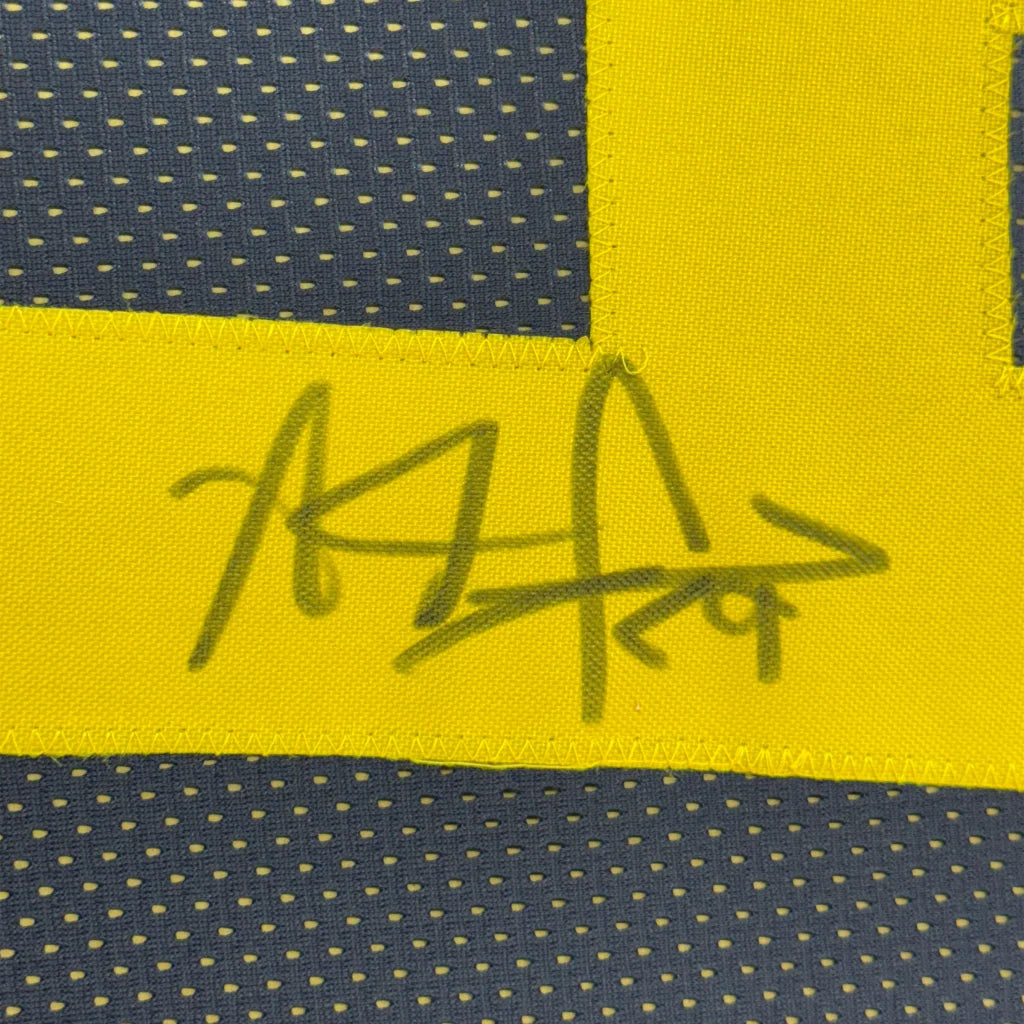 Yellow and navy blue JONES jersey with black marker autograph in display set