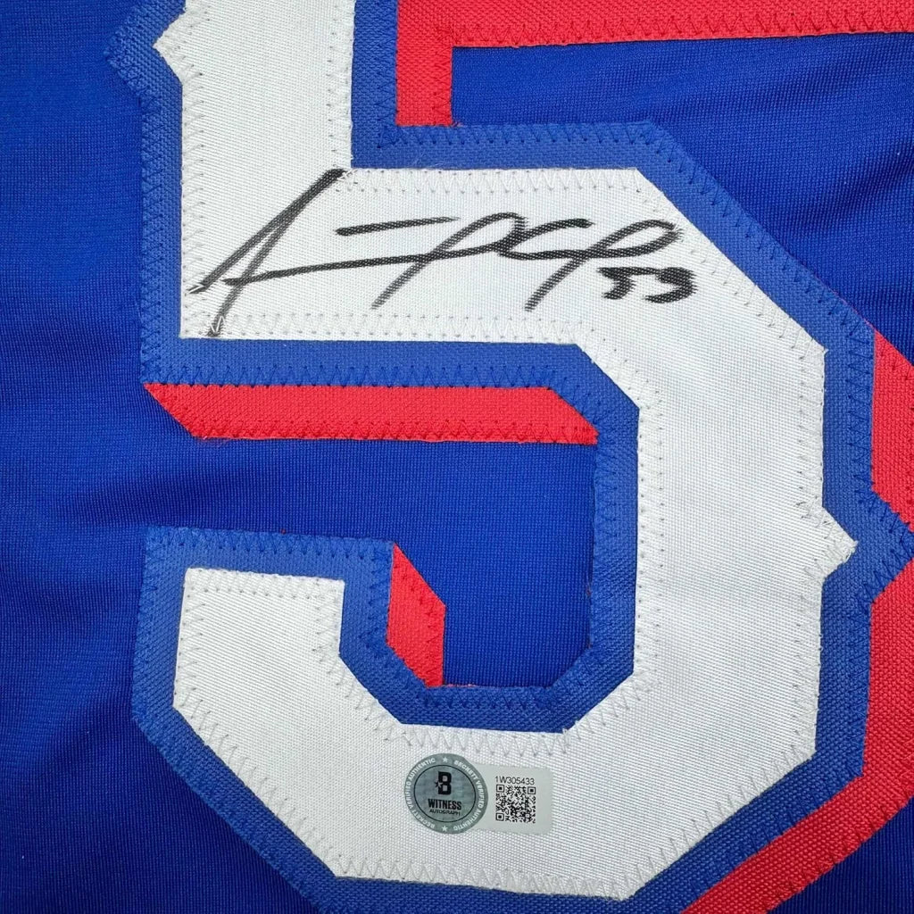Autographed Blue Baseball Jersey with White and Red Number 5 in a frame