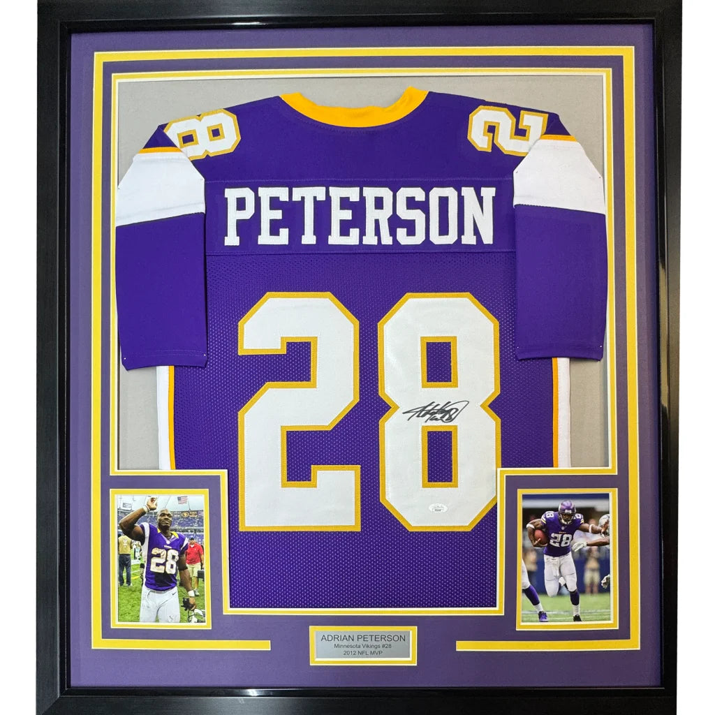 Framed Adrian Peterson Minnesota Vikings #28 signed jersey with player photos on display
