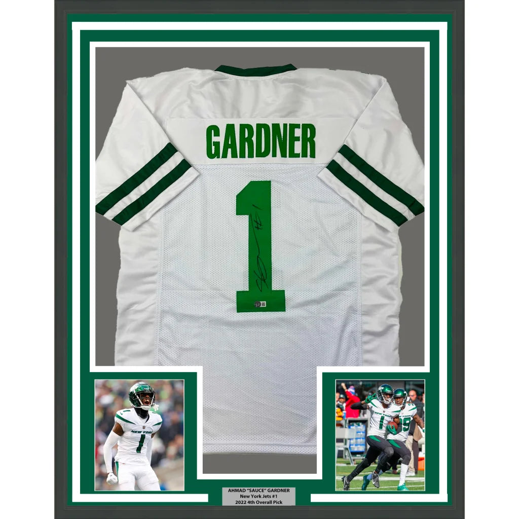 Framed and autographed New York Jets jersey with player photos for display