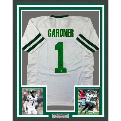 Framed and autographed New York Jets jersey with player photos for display