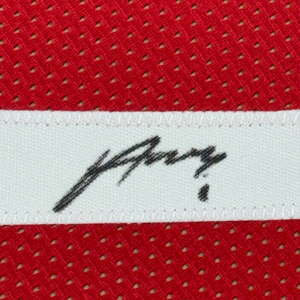 Framed autographed houston red basketball jersey with black signature on white woven label stitched to red mesh fabric
