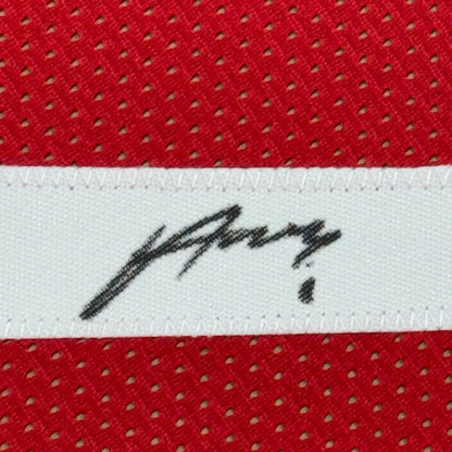 Framed autographed houston red basketball jersey with black signature on white woven label stitched to red mesh fabric