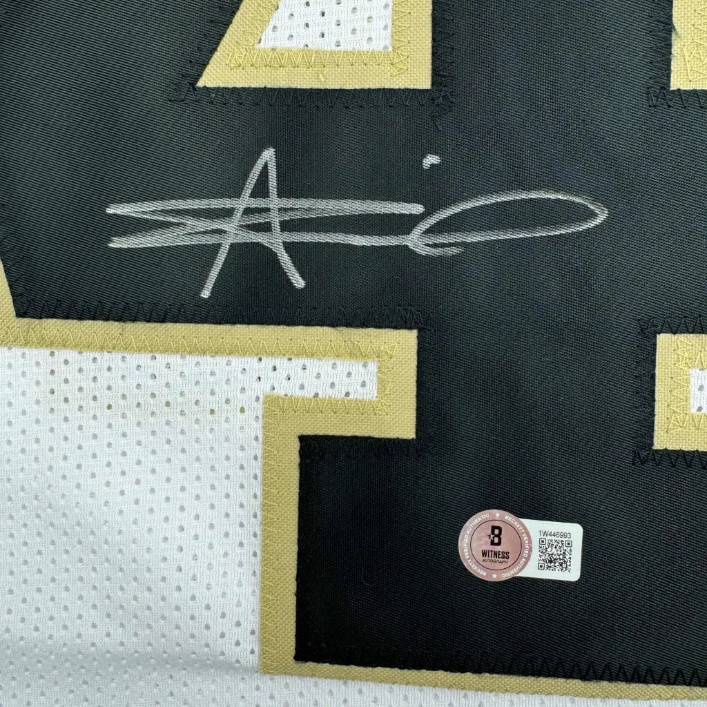 Signed black and gold Alvin Kamara Saints jersey with security hologram ready to display