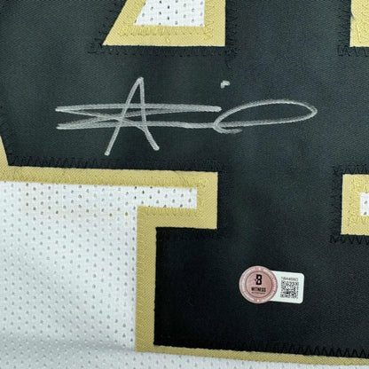 Signed black and gold Alvin Kamara Saints jersey with security hologram ready to display