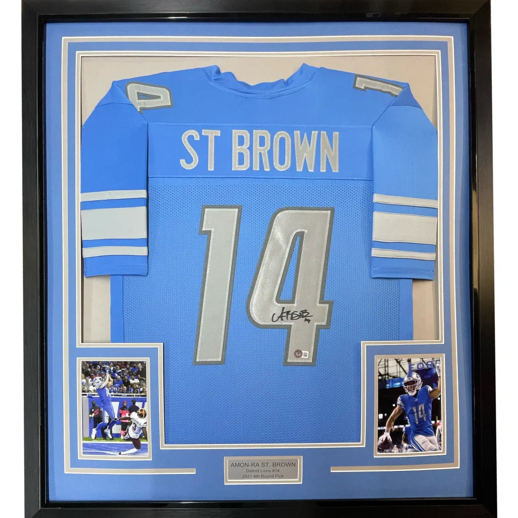 Framed autographed Amon-Ra St. Brown Detroit Lions blue jersey #14 with Beckett COA