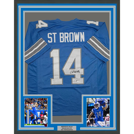 Framed Autographed Amon-Ra St. Brown 35x39 Detroit Current Blue Football Jersey Beckett BAS COA | Hall of Fame Sports Memorabilia | vintageantiquesgifts.com