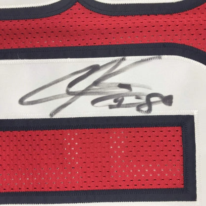 Red and white Houston Texans jersey signed with black marker, perfect for fans