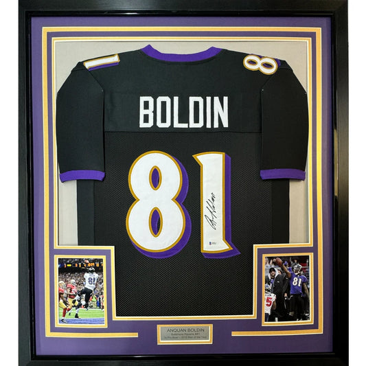 Framed autographed black and purple baltimore ravens jersey with white number 81 and name boldin displayed from back