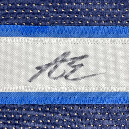 Blue and white perforated mesh basketball jersey with stitched signature label framed and signed by Anthony Edwards