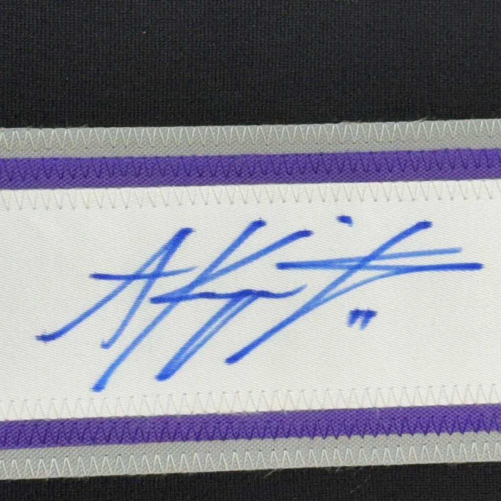 Blue ink autograph on white fabric band with purple and gray trim from Ultimate Man Cave Jersey