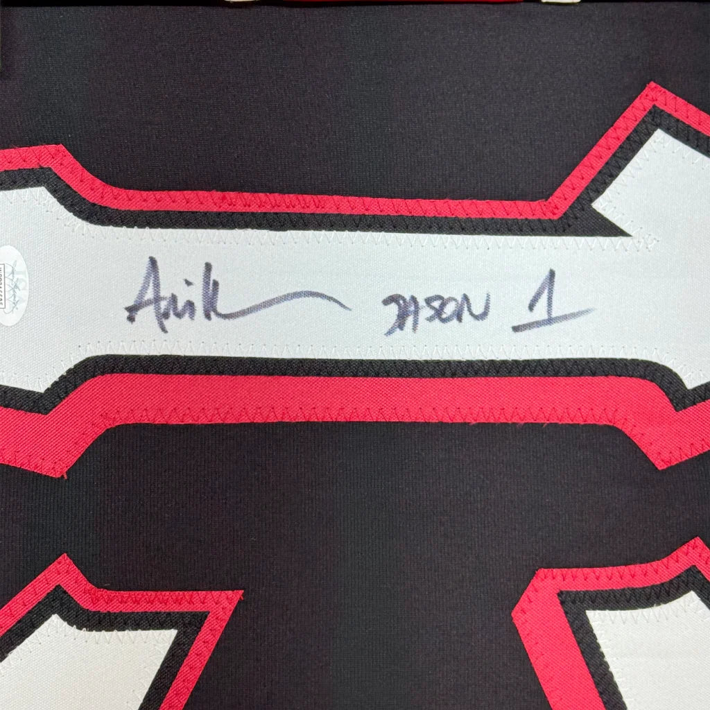 Framed autographed black and red bone-shaped friday the 13th movie jersey with white trim and signature across chest