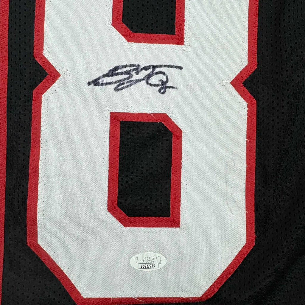 Autographed Black OJULARI Sports Jersey with white and red numbers and certification sticker
