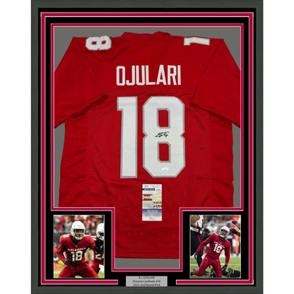 Signed OJULARI football jersey with action shots and authentication, red framed display