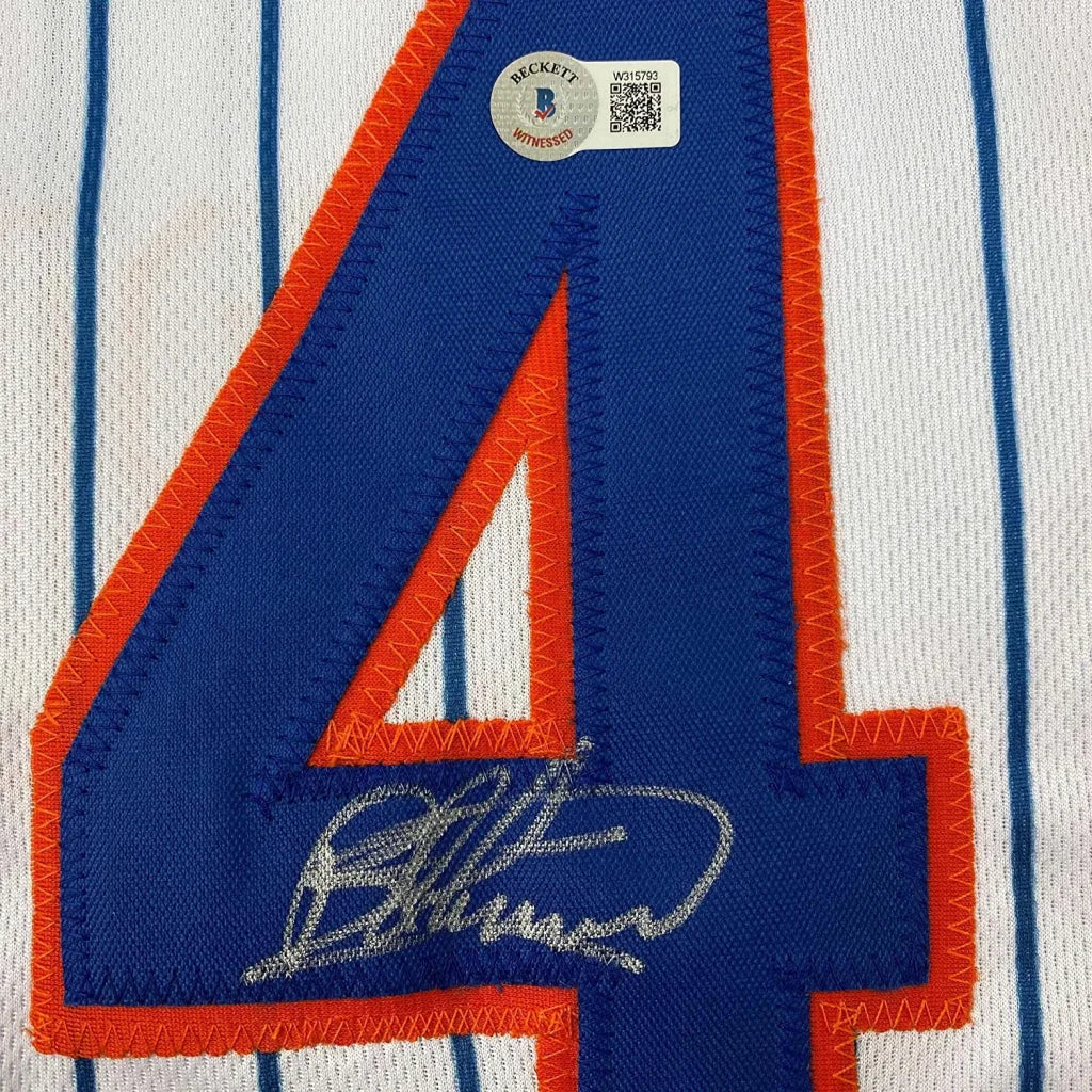 Autographed Bartolo Colon Mets jersey with number 4 framed with photos for display