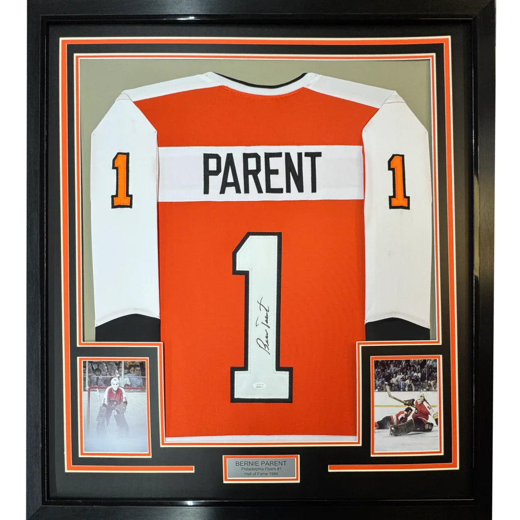 Professionally framed Philadelphia orange hockey jersey with autographs and photos display