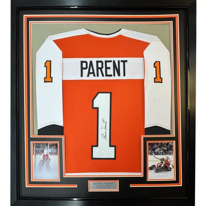 Professionally framed Philadelphia orange hockey jersey with autographs and photos display