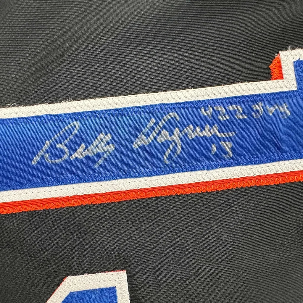 Autographed Black Baseball Jersey with Player Photos in a frame for display