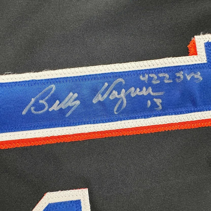 Autographed Black Baseball Jersey with Player Photos in a frame for display