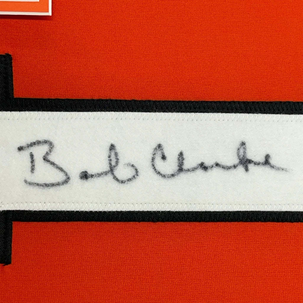Embroidered Bob Clarke signature on white fabric strip with black trim for Jersey display