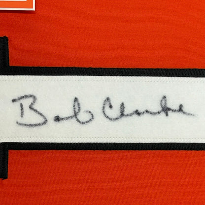 Framed autographed Bob Clarke signature label on orange black Philadelphia jersey