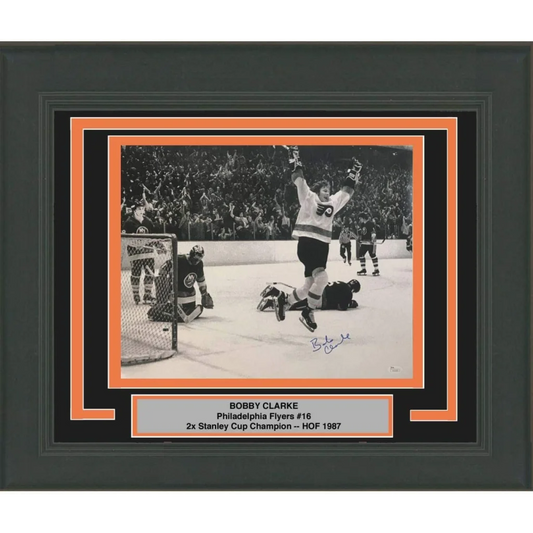Framed black and white photo of Bobby Clarke celebrating in Flyers jersey on ice