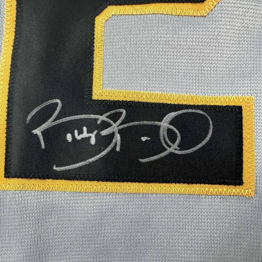 Autographed Pirates jersey with yellow trim, perfect for display and collecting fans