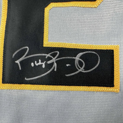 Autographed Pirates jersey with yellow trim, perfect for display and collecting fans
