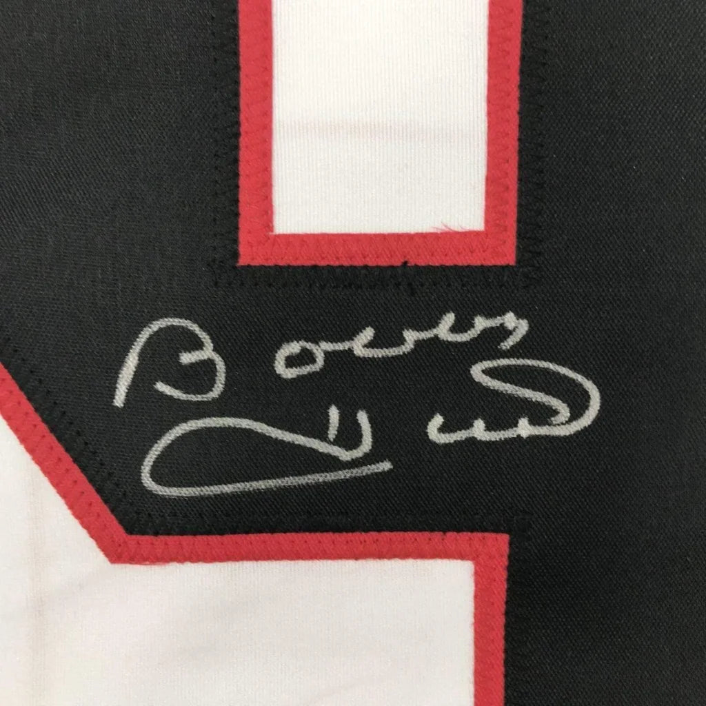 Black and white Chicago White Hockey jersey with red outline and silver autograph in a professionally framed man cave display