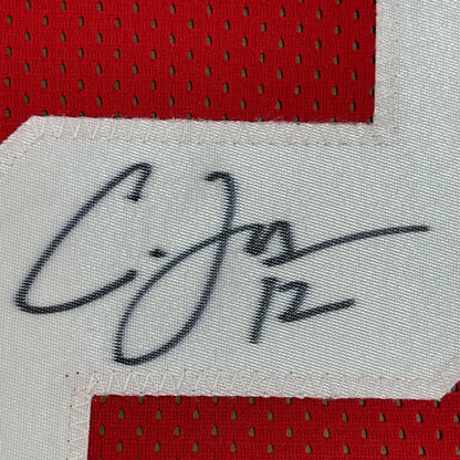 Black ink signature on white mesh fabric bordered by red perforated jersey in framed autographed ohio state football jersey