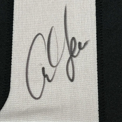 Autographed white textile fabric with black stitching from Legendary USA Track Jersey collectible
