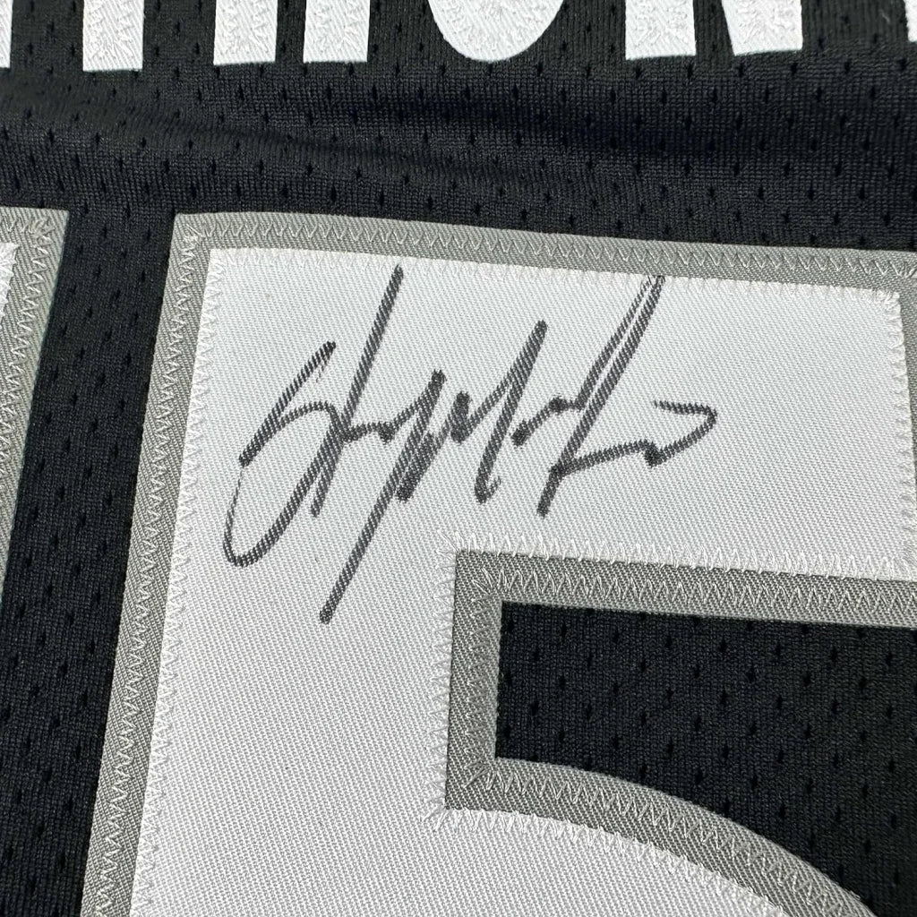Autographed black and white Anthony Basketball Jersey ready for display