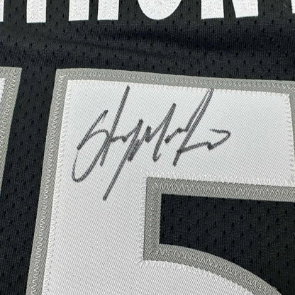 Autographed black and white Anthony Basketball Jersey ready for display