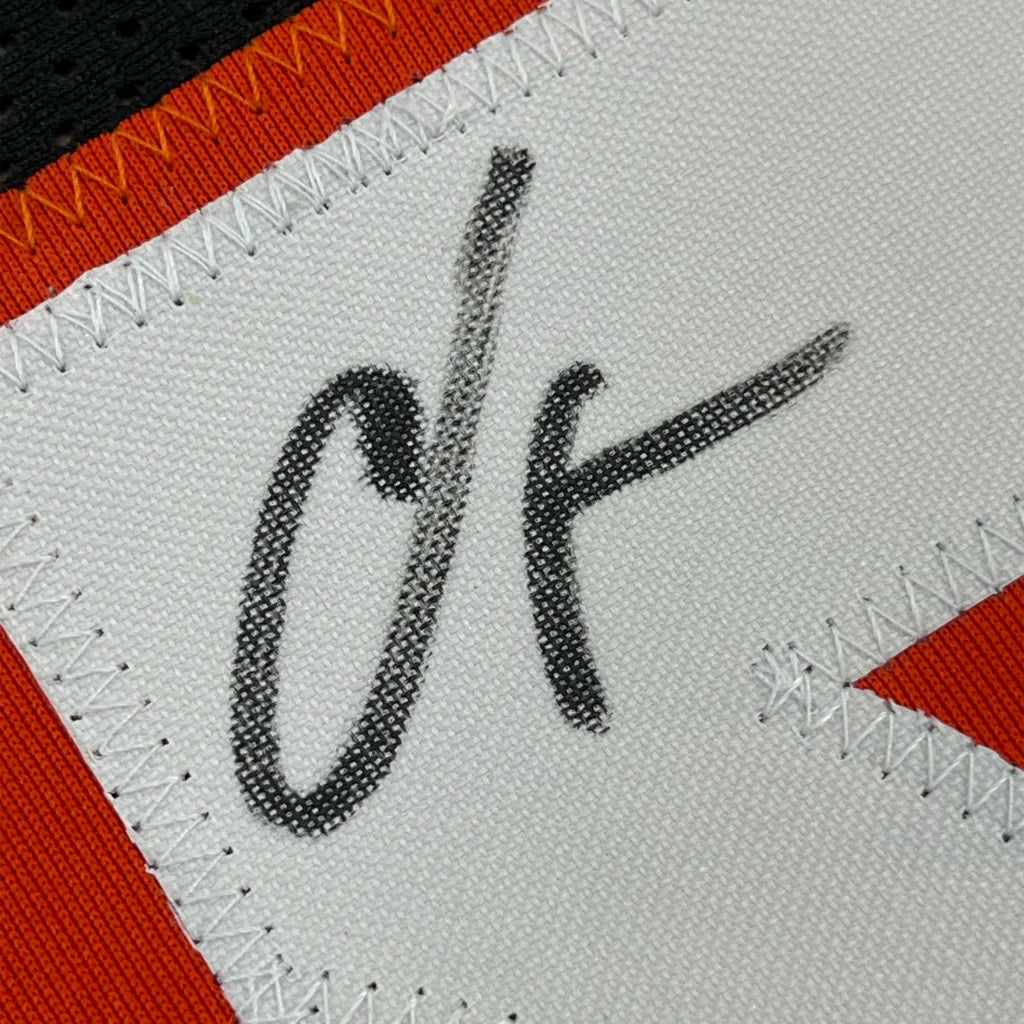 Framed autographed Chad Ochocinco Cincinnati Bengals jersey with black embroidered signature on white patch