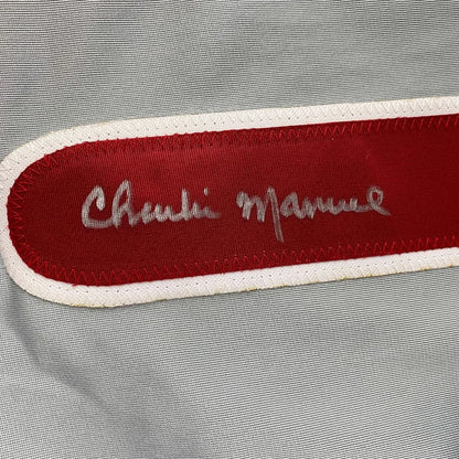 Red Chanel label with silver embroidered script on framed signed Charlie Manuel Phillies jersey