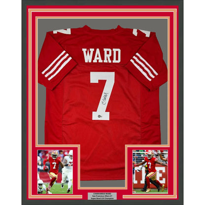 Framed autographed red San Francisco 49ers football jersey with white lettering signed by Charvarius Ward showing back side