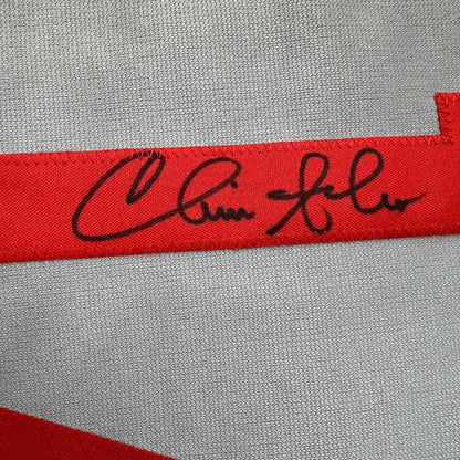 Red fabric ribbon with black embroidered signature on Autographed Baseball Jersey with Photos