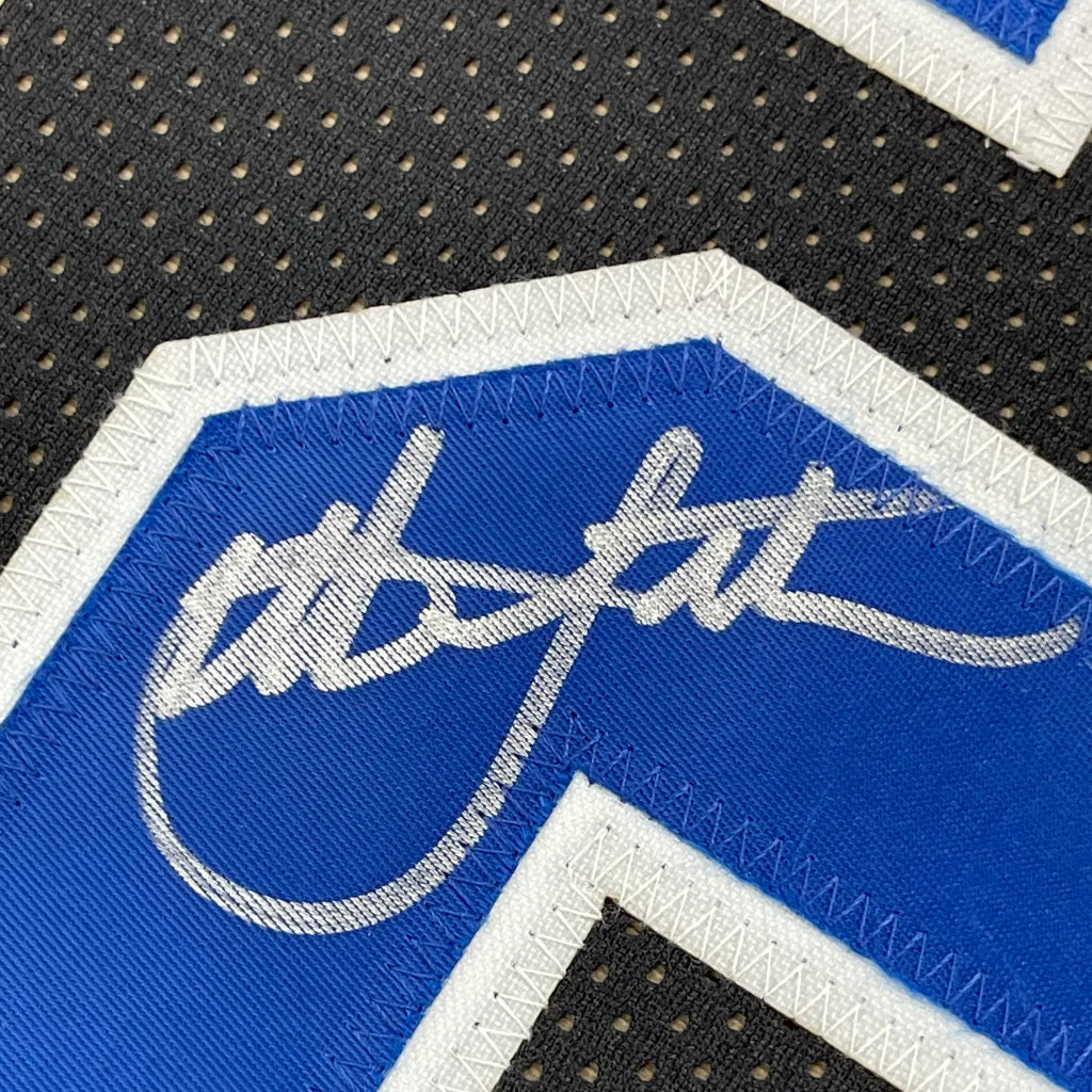 Signed blue and black Duke jersey from Christian Laettner with photos in a museum frame