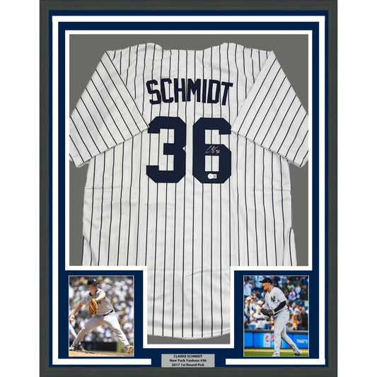 Framed Clarke Schmidt Yankees jersey with autographs and two player photos ready to hang